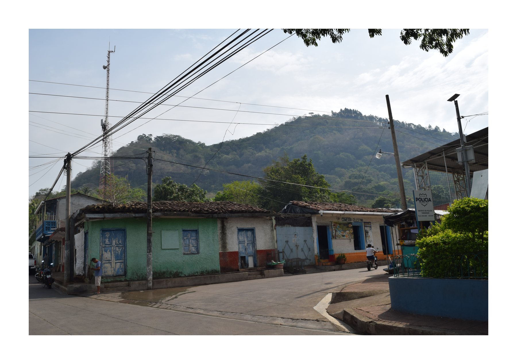 Quiet street with green hills in the background
