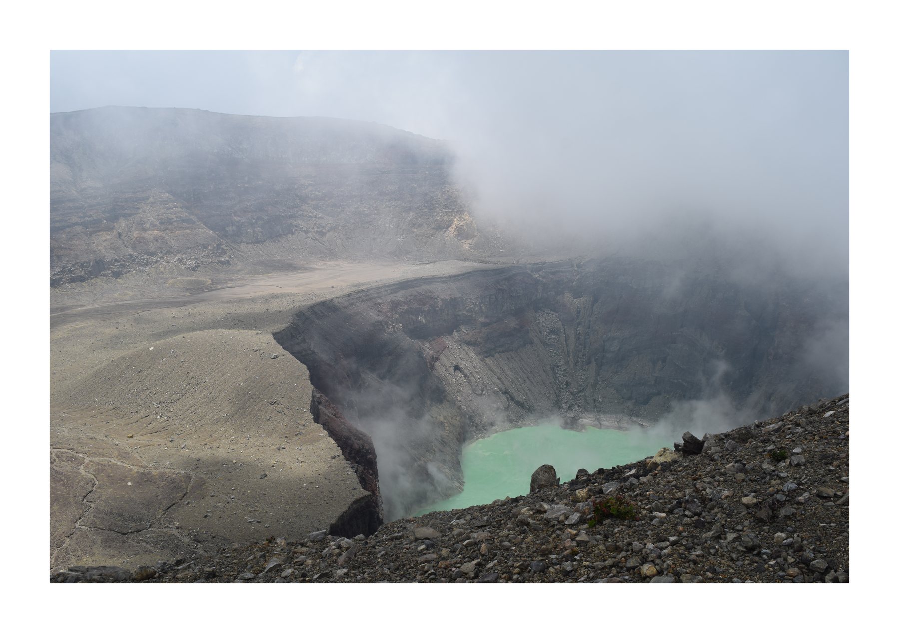 Volcanic crater lake under low clouds