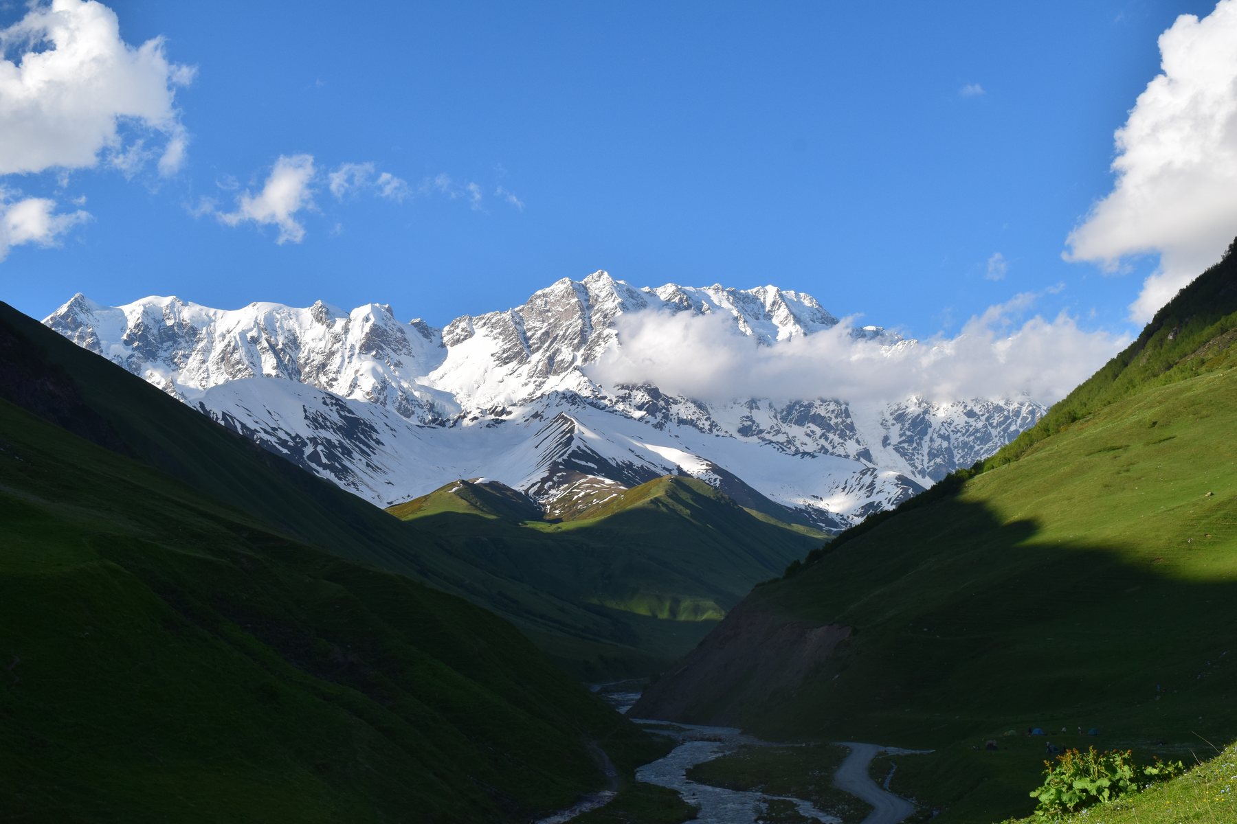 Snow-capped mountains above a green valley in Georgia