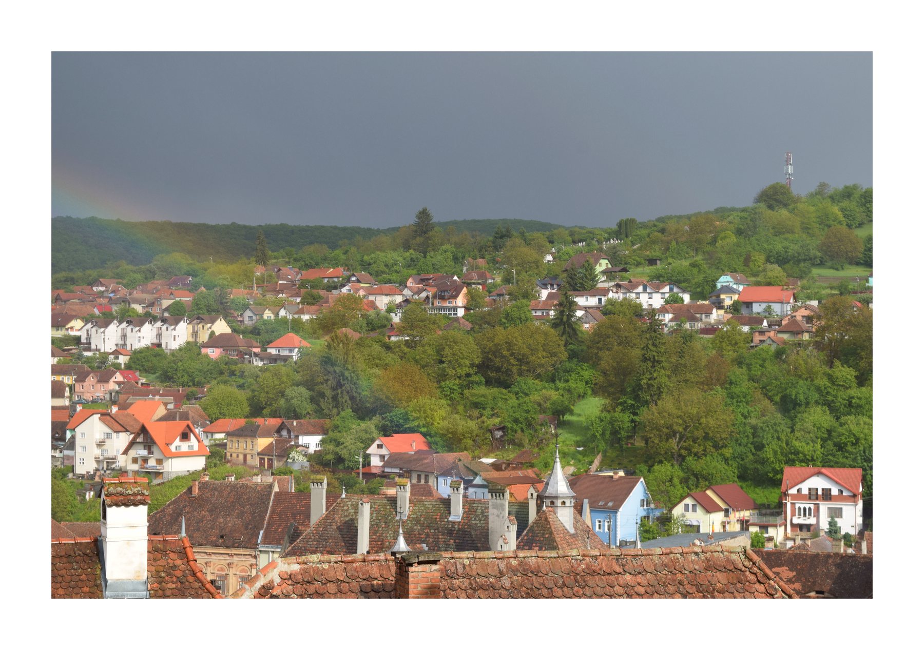 Rainbow over a Romanian hillside town