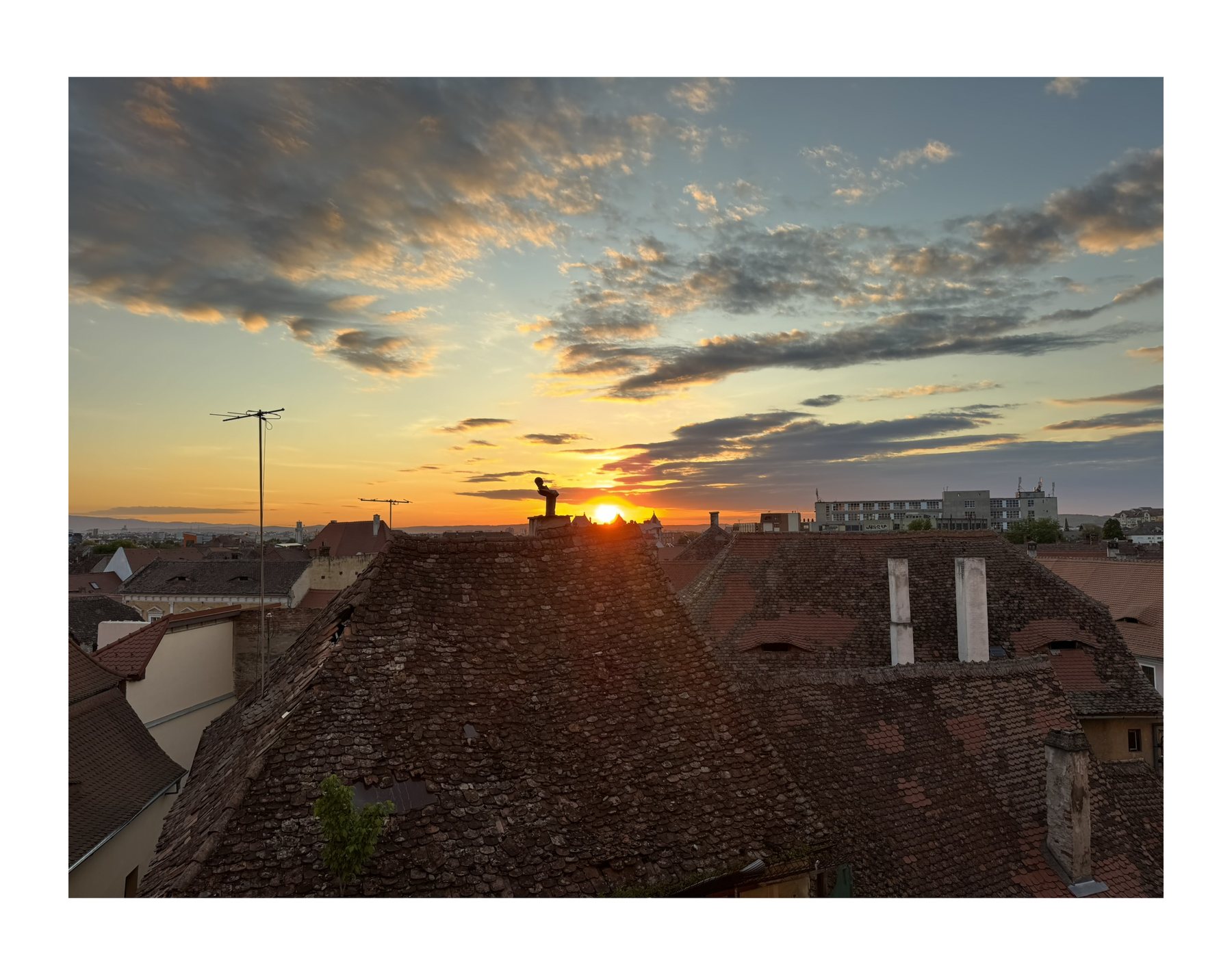 Sunset over rooftops in Romania